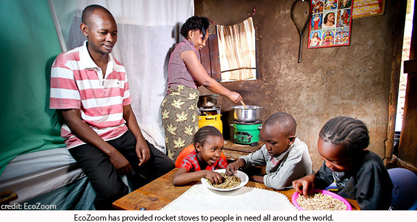 family enjoying food cooked on EcoZoom rocket stove